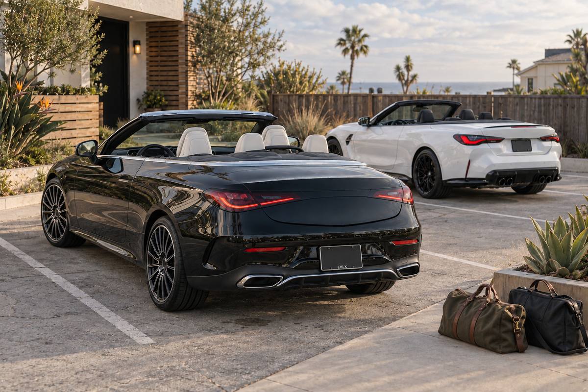 Black and white convertibles in separate spaces beside a beach-neighborhood home.