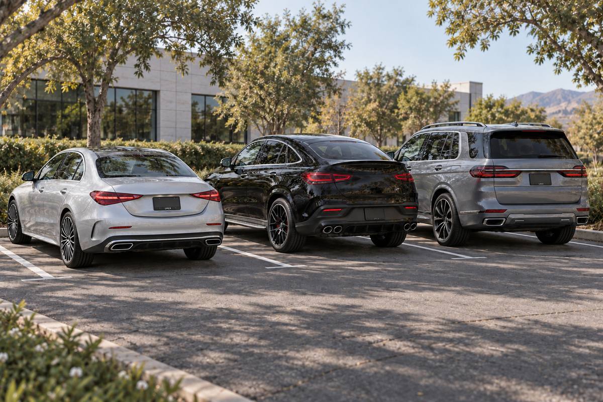 Silver sedan, black coupe SUV and gray three-row SUV parked in separate courtyard spaces.